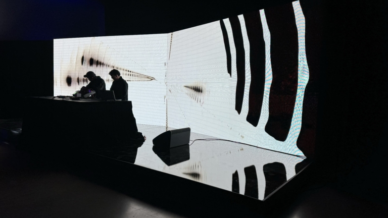 Curved LED video wall behind a stage deck with performers